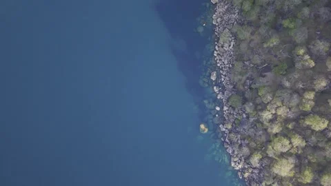 Drone flies in bird's eye view over gap between Cape Maclear and Domwe Island Stock Footage 339549245
