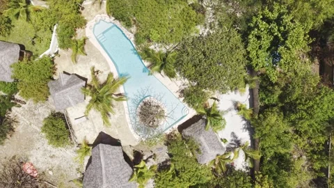 Drone flies in bird's eye view over resort with swimming pool near Mtende Stock Footage 344171441