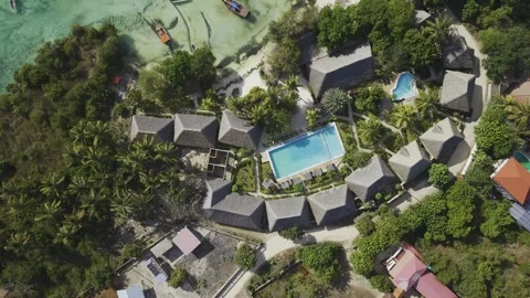 Drone flies in bird's eye view of seaside resort next to popular beach Stock-Footage 346482179