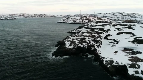 The drone flies in the black waters of the ocean that wash the rocky shore Stock Footage 169464301