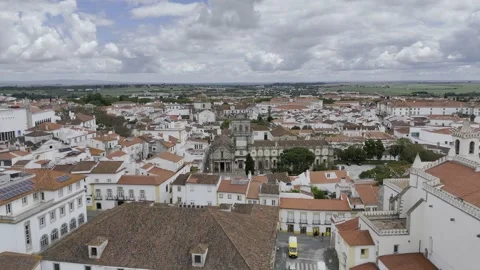 Drone flies by the Chapel of Bones toward Graca Church in Evora, Portugal Stock Footage 311786906
