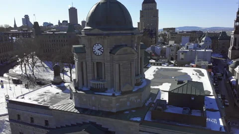 Drone Flies from Clock Tower flying Canadian Flag to Reveal Snow Covered 스톡 동영상 139762195