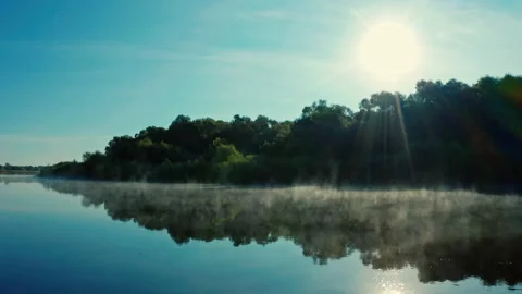 Drone flies close to water surface while morning evaporation. Beautiful morni Vídeos de archivo 138165373