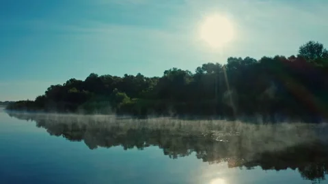 Drone flies close to water surface while morning evaporation. Beautiful mor.. Video stock 307159036