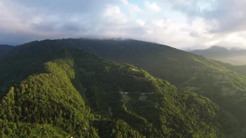 Drone flies closer to misty mountain peaks at golden sunset, Adjara, Georgia 스톡 동영상 337335079