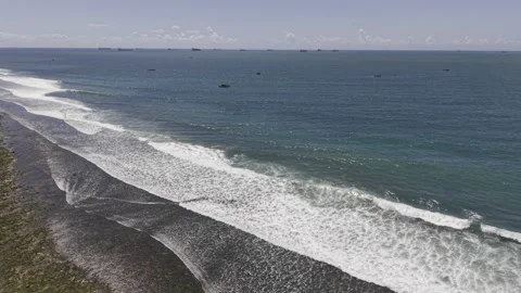 Drone flies from Coco Beach at low tide out to sea over fishing boats Video stock 342162008