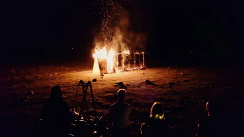 Drone flies to a construction on fire and people watching Stock Footage 253975914