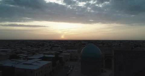 The drone flies at dawn over the old Bukhara and the memorial famous Kalyan Poi Stock Footage 244789473