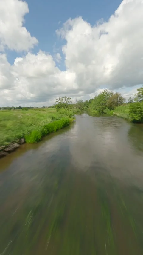 Drone flies down river to reveal maize maze Stock Footage 244427493