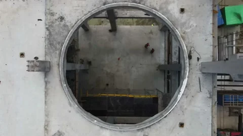 Drone flies down through the ceiling hole in a concrete building. 動画素材 156072862