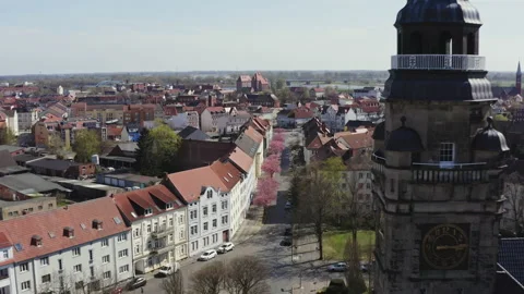 The drone flies downwards very close to the tower of the town hall over the Stock Footage 163124064
