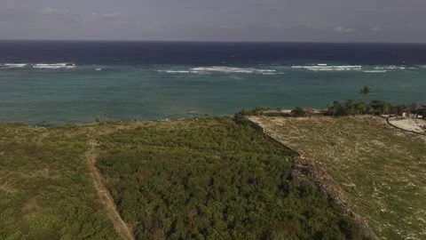 Drone flies east over cliff to Indian Ocean at high tide on a sunny afternoon Stock Footage 344110954