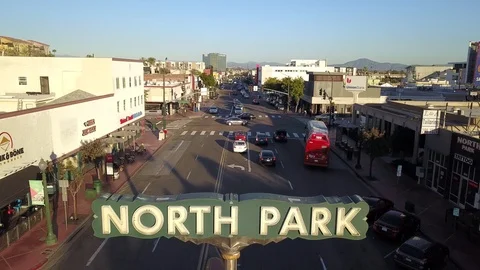 Drone flies fast over NORTH PARK sign in San Diego facing east Stock Footage 102821704