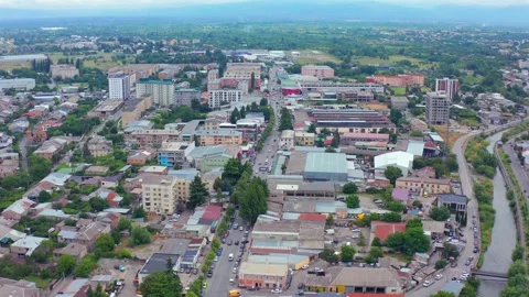 Drone flies forward above central Gori in Georgia, crossing commercial streets Stock Footage 340768385