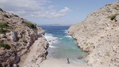 Drone flies forward between narrow rocky canyon nature and blue sea. Stock Footage 168254601