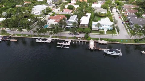 Drone flies forward over Florida island neighborhood with docks, pools and h Stock Footage 343306355