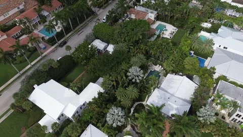 Drone flies forward over Florida island neighborhood with rooftops and pools Stock Footage 343306838