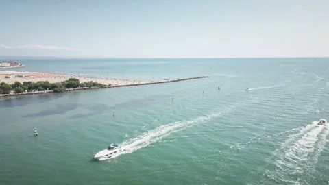 Drone flies forward over Grado inlet with two motorboats 4K Vídeo Stock 331403173