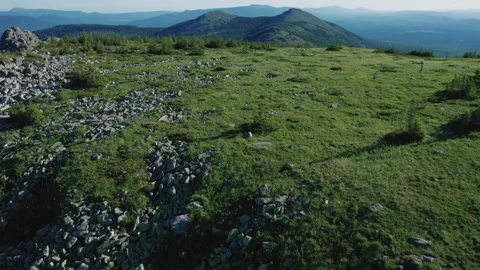 Drone flies forward over mountain range on sunset. Silhouette of peaks of mount Stock Footage 138002181