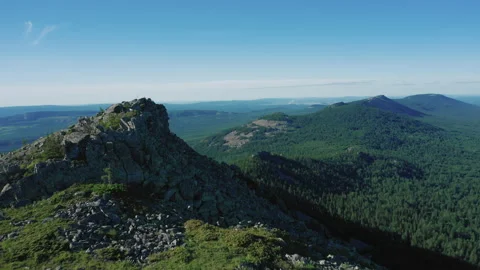 Drone flies forward over mountain range on sunset. Silhouette of peaks of mount Stock Footage 138003257