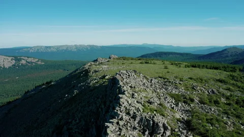 Drone flies forward over mountain range on sunset. Silhouette of peaks of mount Stock Footage 138005089