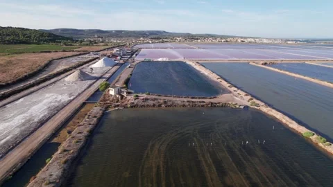 Drone flies forward over salt pans and salt mounds in Gruissan Stock Footage 346288475