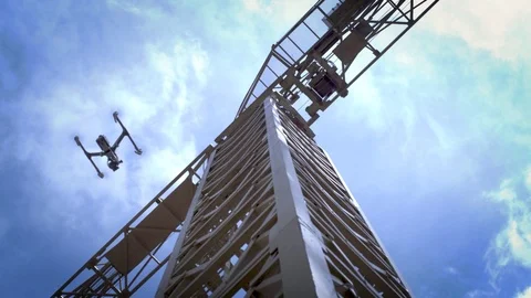 Drone flies in front of construction crane.  Shot from below drone. Stock Footage 80152098