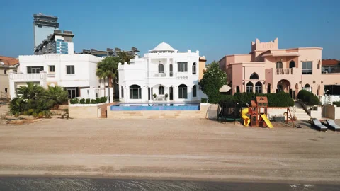 A drone flies in front of the facade of a luxury private villa with a swimming Stock Footage 308280221