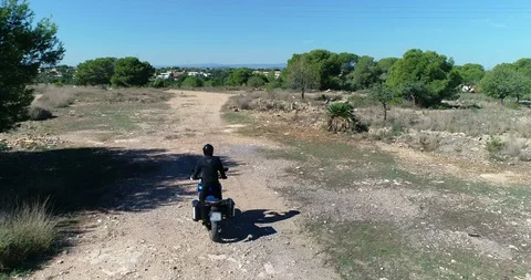 Drone flies in front of large-displacement motorcycle trail riding Stock Footage 124364595