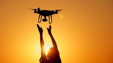 Drone flies from the hands of the boy at sunset Stock Footage 80500988