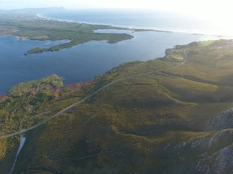 Drone flies high above winding road in Hermanus, South Africa 스톡 동영상 79708640