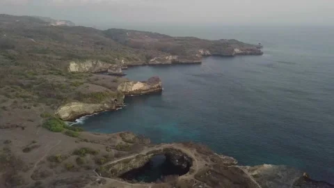 The drone flies at high altitude over the sea and mountains. Video stock 155987796