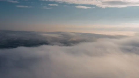 Drone flies high back in blue sky through fluffy clouds in winter morning time Stock Footage 293671003