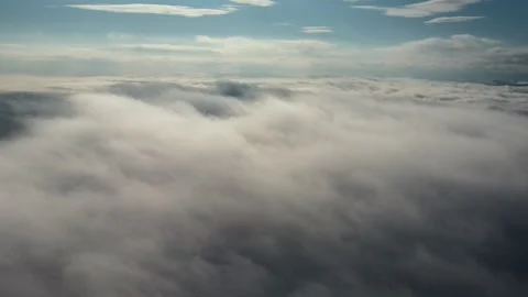 Drone flies high back in blue sky through the fluffy clouds in morning Stock Footage 293671207