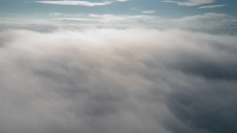 Drone flies high back in blue sky through fluffy clouds in winter morning time Stock Footage 293671265