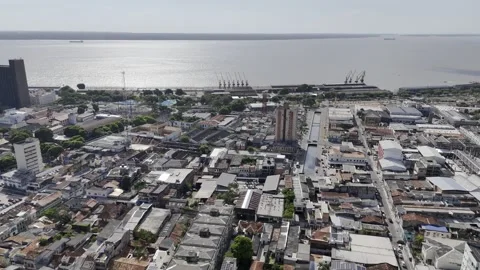 Drone flies high over city toward docks on Guamá River in Belém, Pará, Brazil Vídeo Stock 284472136