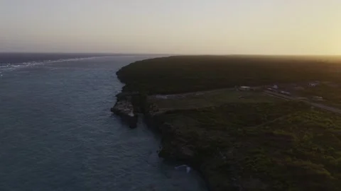 Drone flies high over coast of Mtende Beach at high tide at sunset in Zanzibar Stock Footage 344164511
