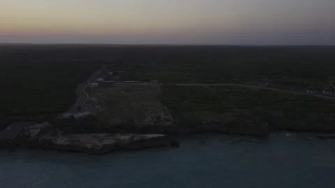 Drone flies high over Mtende Beach from the Indian Ocean after sunset Stock Footage 344243930