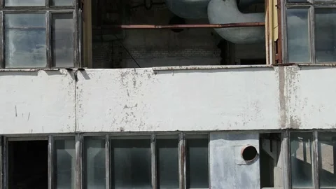 Drone flies inside a Smashed Windows of an Abandoned Soviet Chemical Factory 4k Stock Footage 135897484