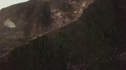 A drone flies off a large mountain in Bali. Stock Footage 155987518