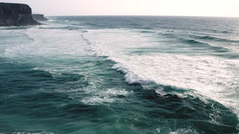 Drone  flies low over closer the ocean waves along the rocky shore, in summer Stock Footage 198427746