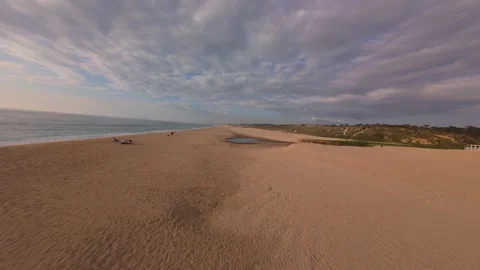 Drone flies low over empty beach near water Stock Footage 340225663