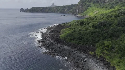 Drone flies low over Enseada do Carreiro de Pedra toward Morro do Pico Stock Footage 280251360