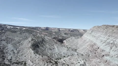 Drone Flies Low Over High Desert Outcropping Then Launches Over Canyon, Colorado Stock Footage 200181708