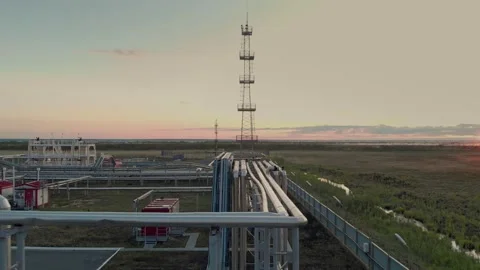 A drone flies low over a pipeline in a closed area of a gas processing complex Video stock 163536258