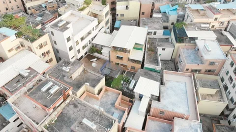 Drone flies low over the roofs of a densely built area Video stock 113281615