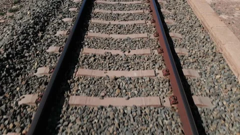 The drone flies low over the tracks of a railway line. Stock Footage 152856256