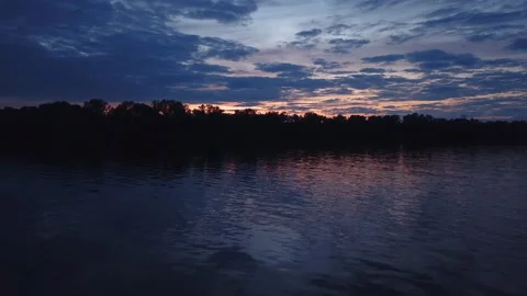 Drone flies low over water during sunset. Stock Footage 131920510