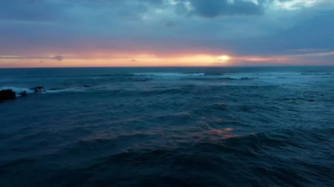 Drone flies low over the waves during sunset with blue clouds. Beautiful oc.. Stock Footage 253269944