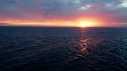 Drone flies low over the waves during sunset with reflection on water. Beau.. Stock Footage 253270473